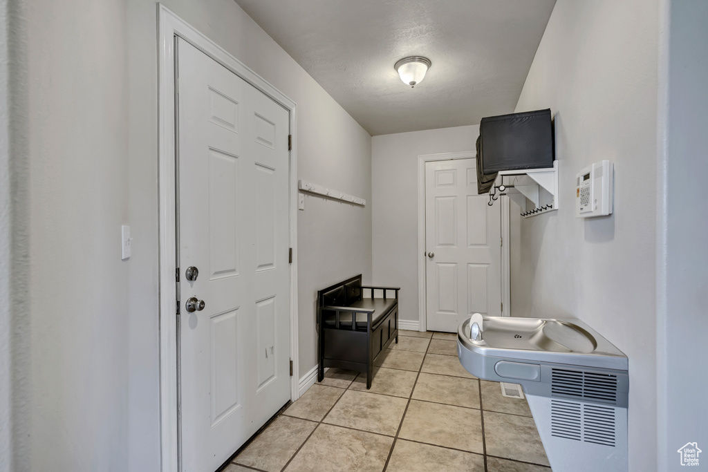 Washroom with light tile patterned floors and baseboards