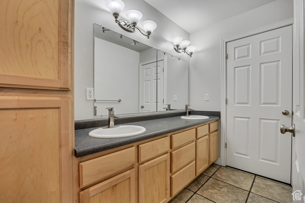 Full bath featuring double vanity and tile patterned floors