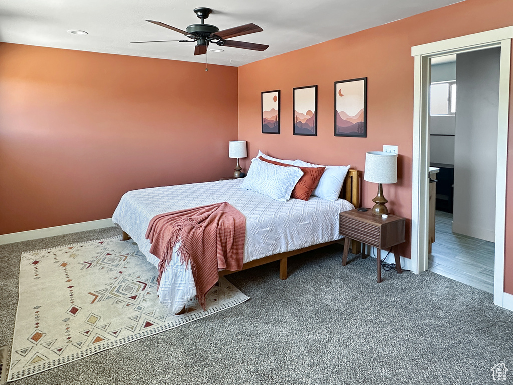 Carpeted bedroom featuring baseboards and a ceiling fan