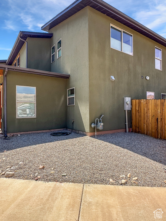 Rear view of property featuring stucco siding