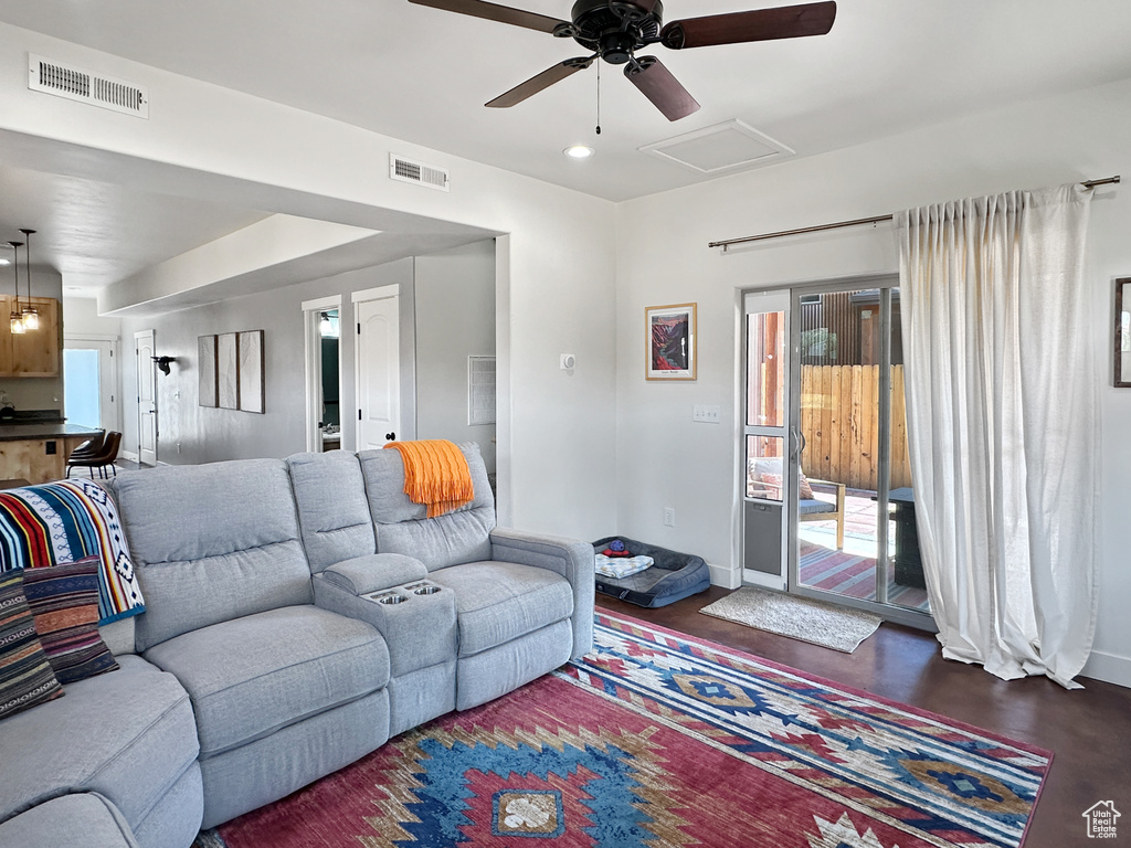 Living area with attic access, ceiling fan, baseboards, and recessed lighting