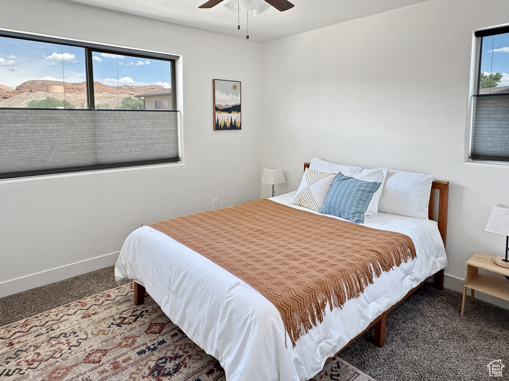 Bedroom with carpet flooring, baseboards, and ceiling fan