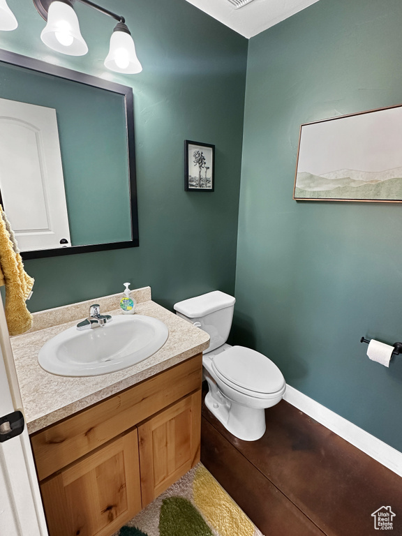 Half bathroom with vanity and toilet