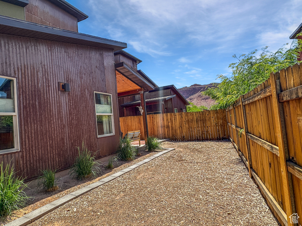 Fenced backyard featuring a mountain view