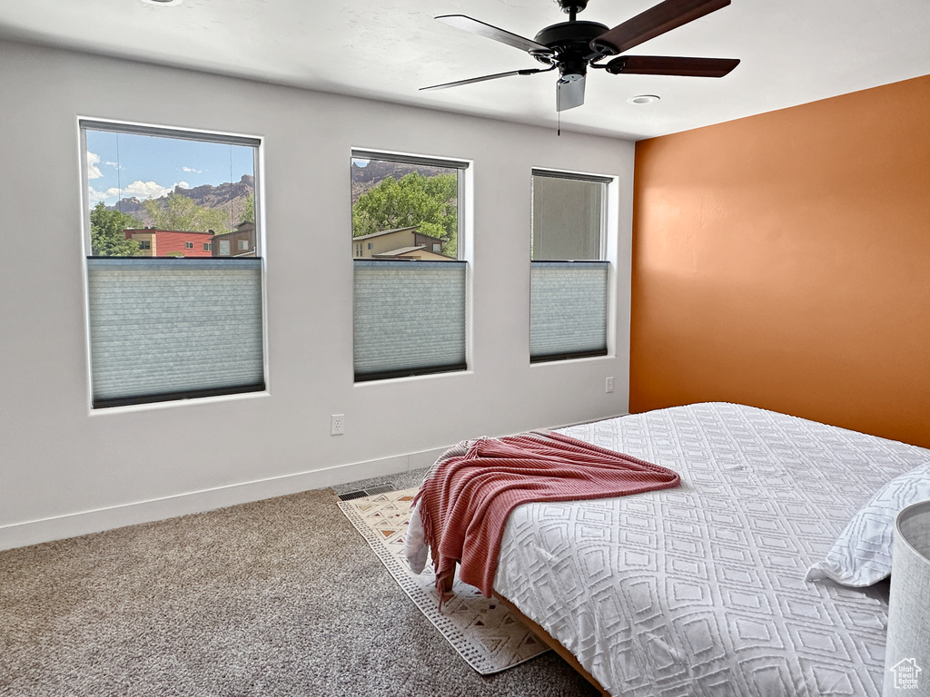 Bedroom featuring carpet flooring, baseboards, and a ceiling fan