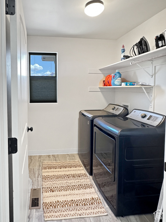 Laundry room with separate washer and dryer and baseboards