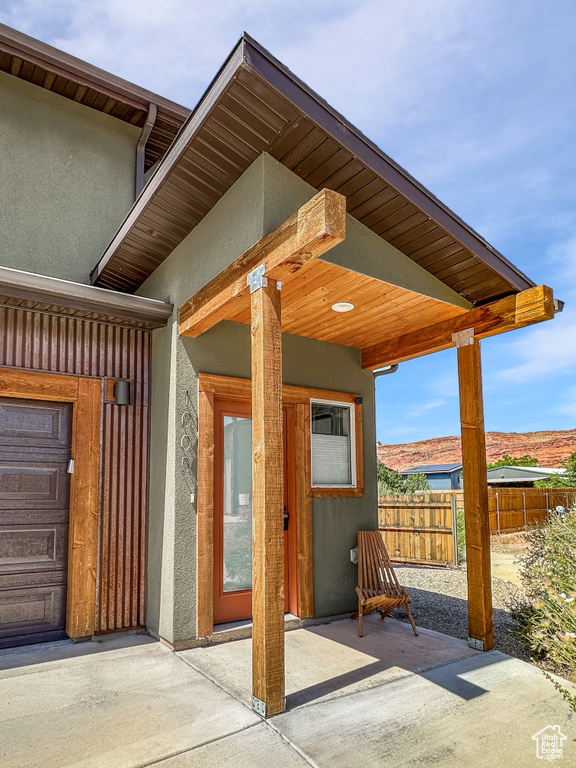 Doorway to property featuring stucco siding