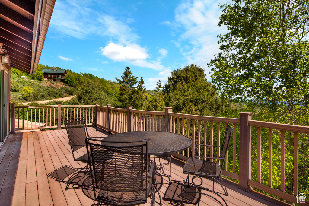 Wooden terrace featuring outdoor dining area