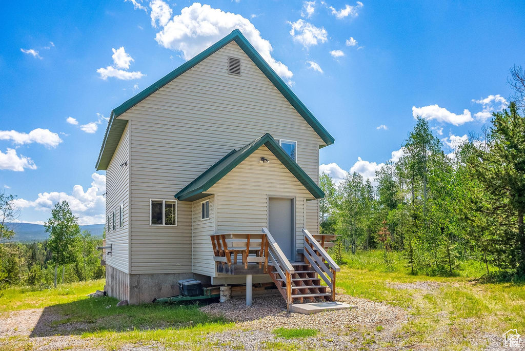 Back of property featuring a wooden deck