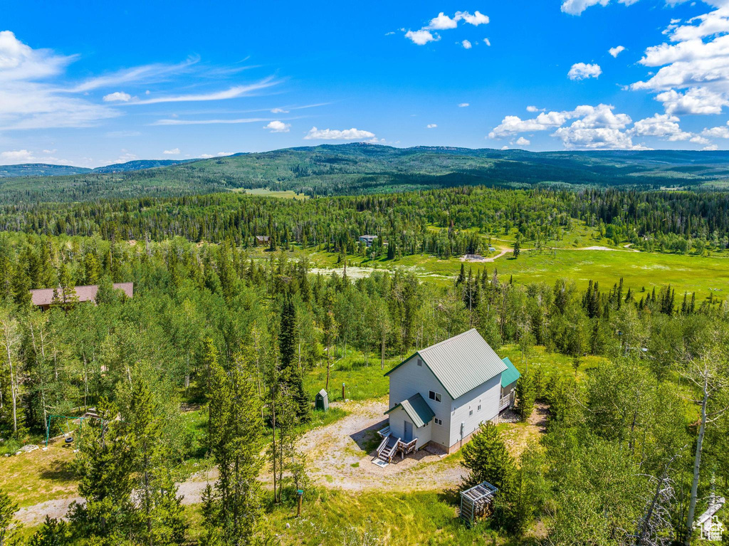 View from above of property featuring a heavily wooded area and mountains