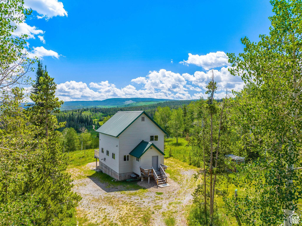 Aerial view of property and surrounding area featuring a heavily wooded area