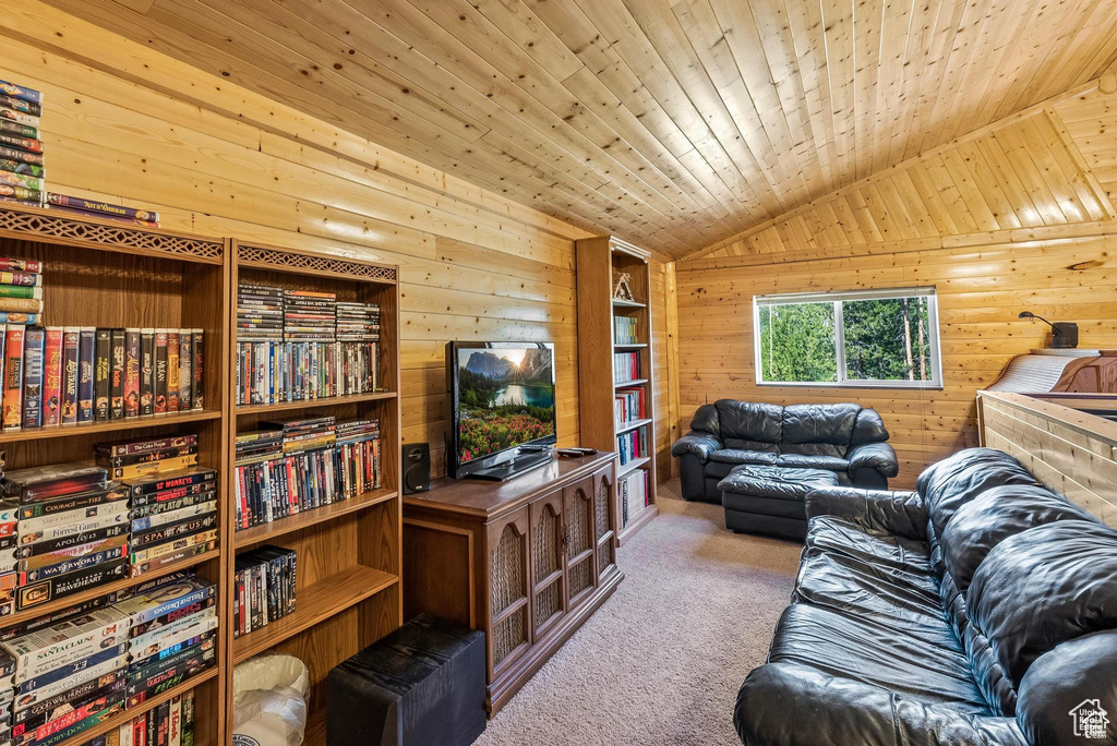 Living room featuring carpet, lofted ceiling, wooden walls, and wooden ceiling