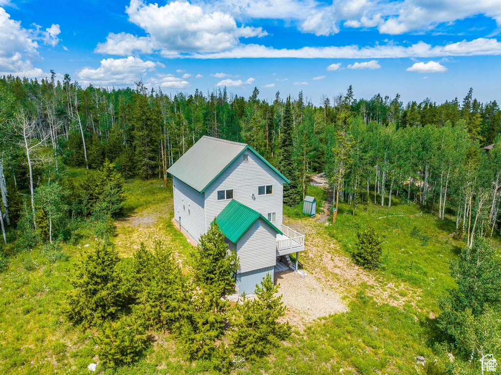 View of subject property with a heavily wooded area