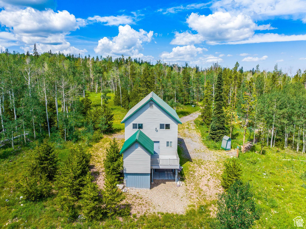 View of subject property with a forest