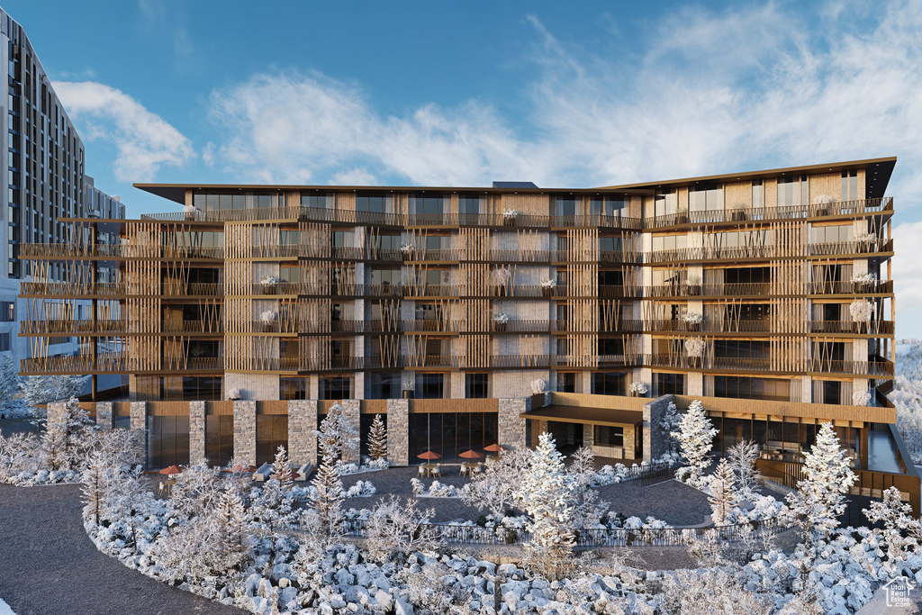 Snow covered property featuring a view of apartment building / complex