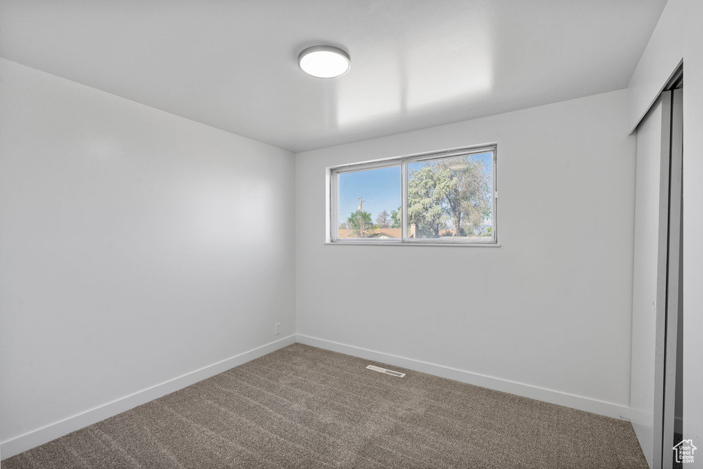 Unfurnished bedroom with carpet, baseboards, and a closet
