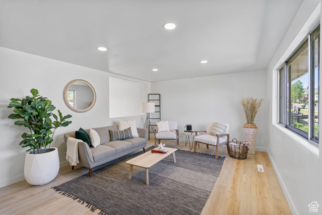 Living area featuring wood finished floors, recessed lighting, and baseboards