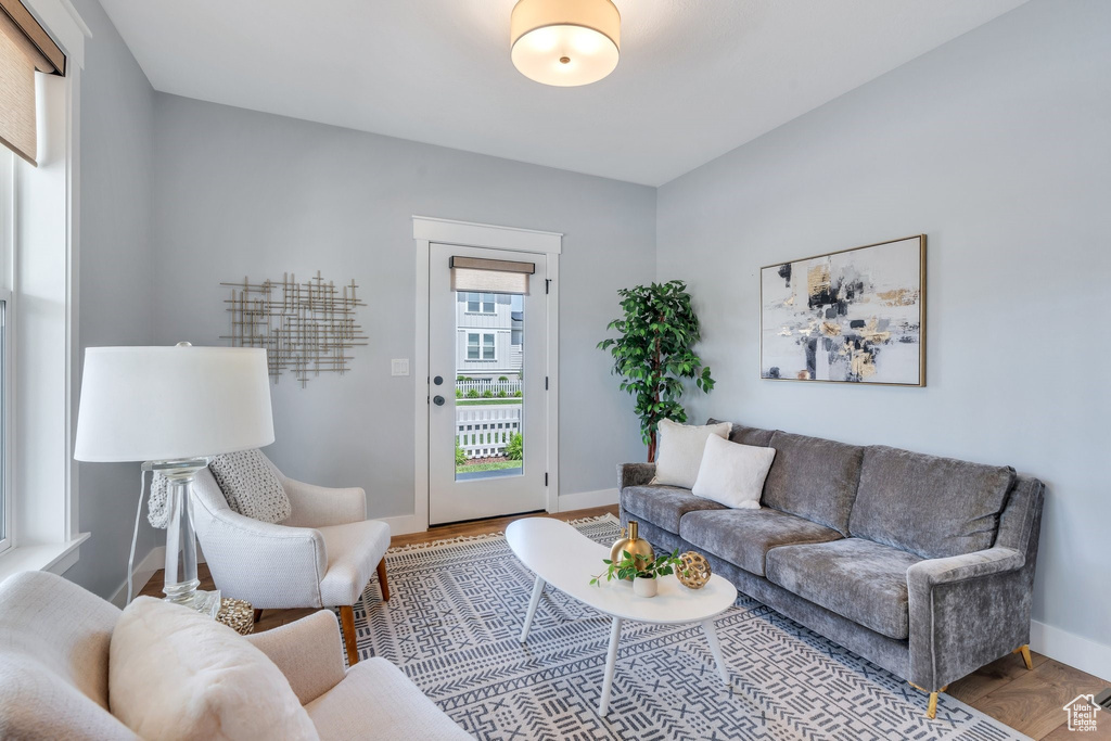 Living area with baseboards and wood finished floors