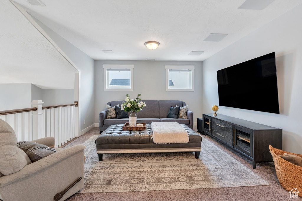 Carpeted living room featuring baseboards
