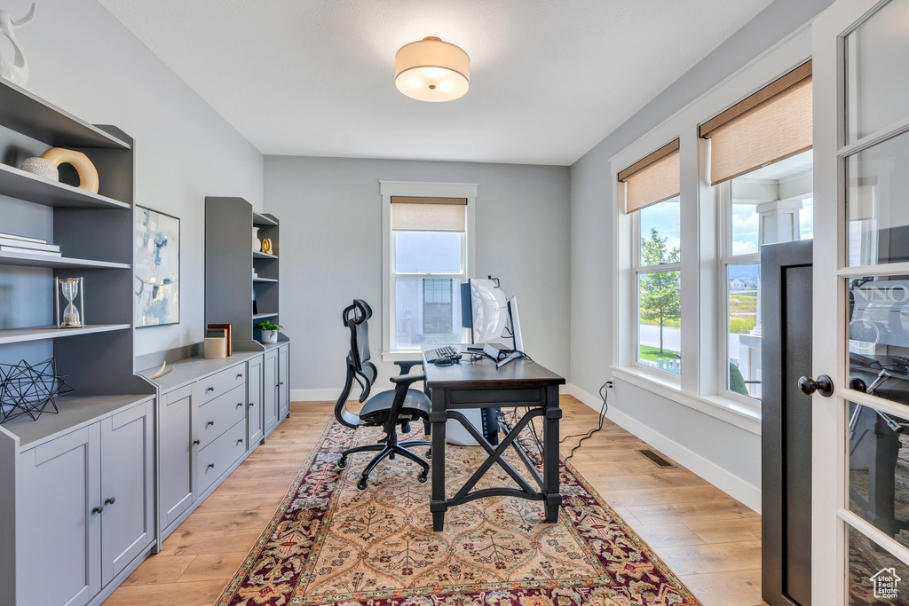 Office area featuring light wood-type flooring and baseboards