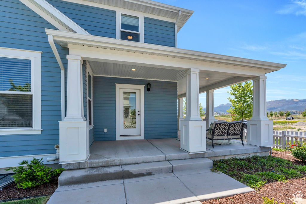 View of exterior entry with covered porch and a mountain view