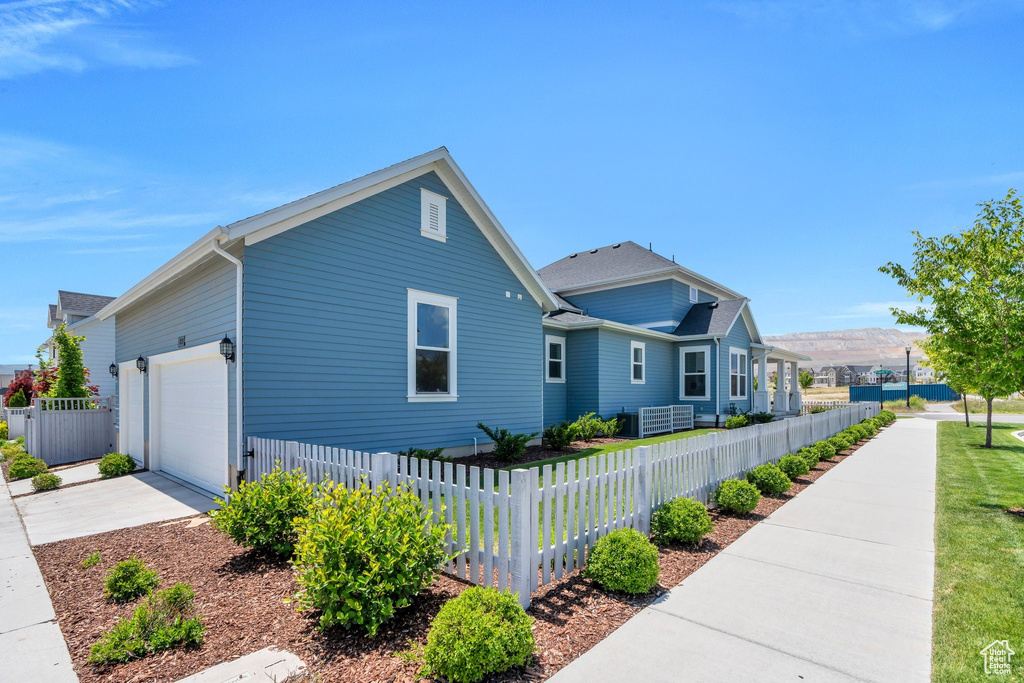 View of front of property with a garage and concrete driveway