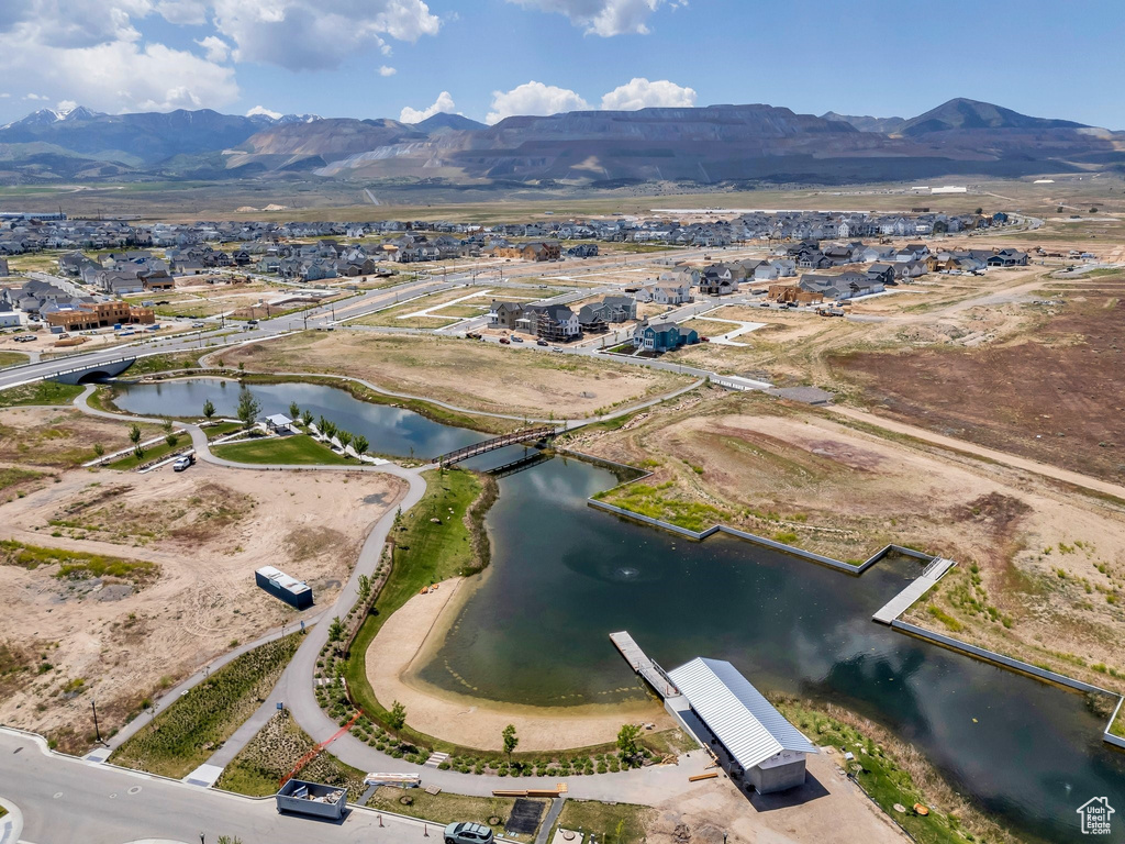 Aerial view of property's location with a water and mountain view and nearby suburban area