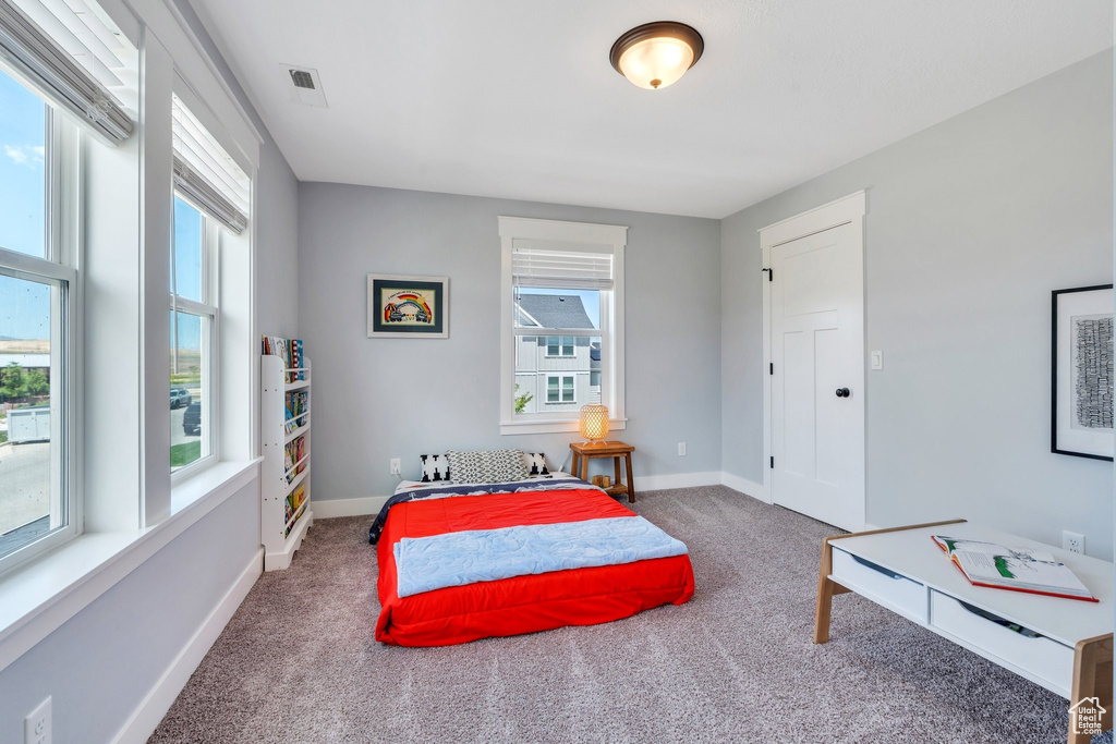 Carpeted bedroom featuring baseboards