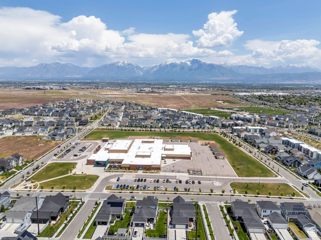 Aerial view of property's location featuring a mountainous background and nearby suburban area