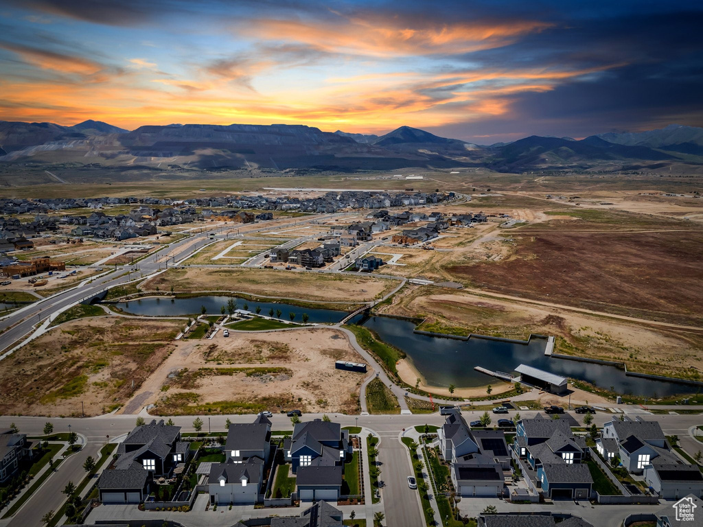 Aerial view of property's location featuring a water and mountain view and nearby suburban area