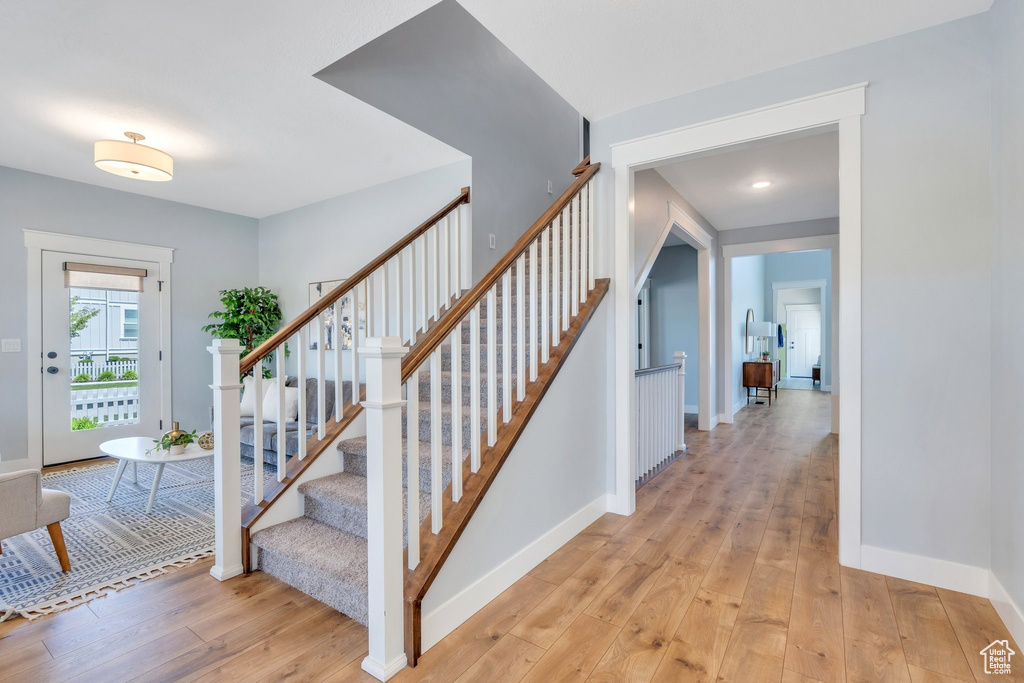 Stairway featuring wood-type flooring and baseboards