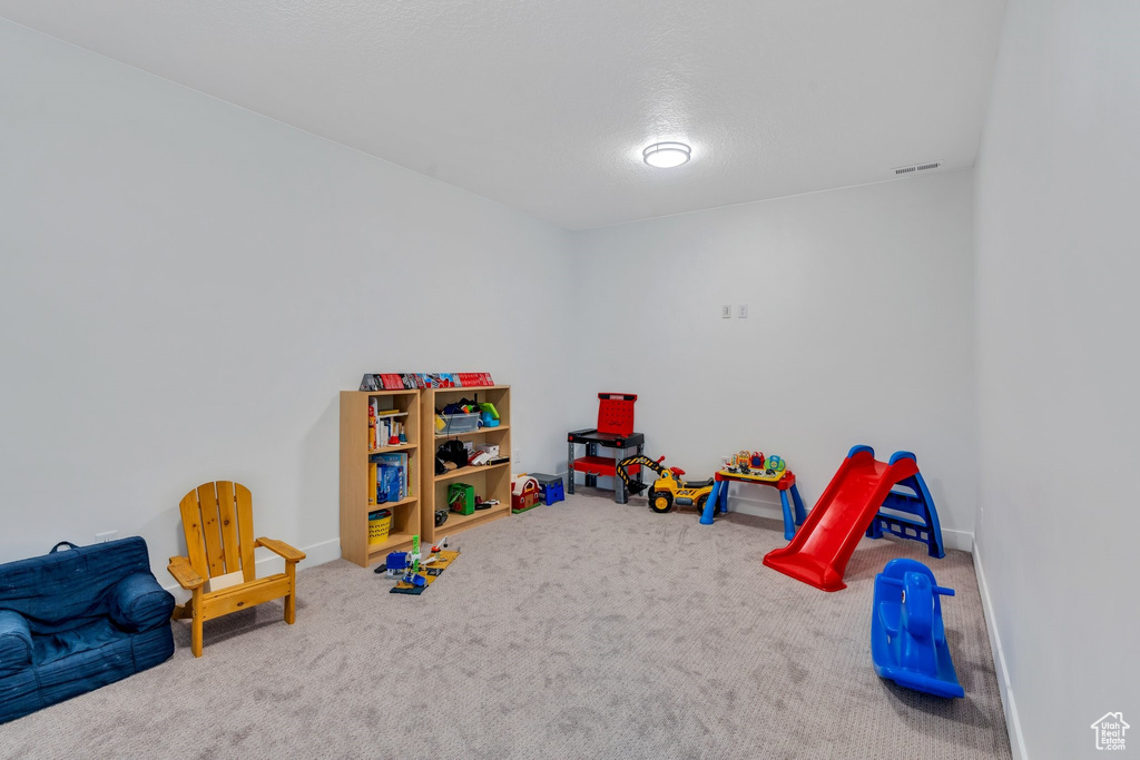 Recreation room with carpet and baseboards