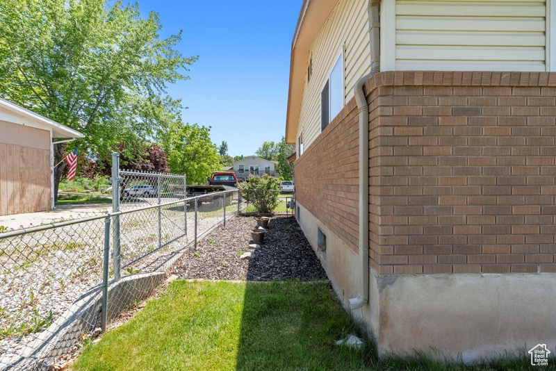 View of property exterior with brick siding