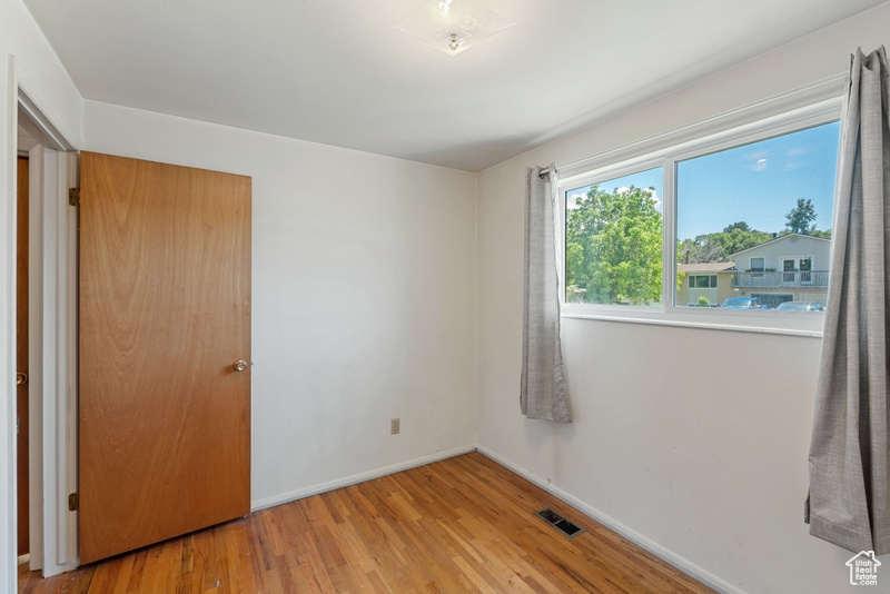 Unfurnished bedroom featuring light wood-style flooring and baseboards