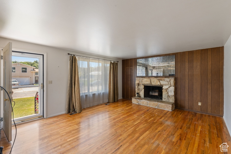 Unfurnished living room featuring light wood finished floors and a fireplace