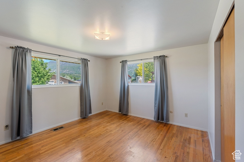 Empty room featuring light wood-style floors and baseboards