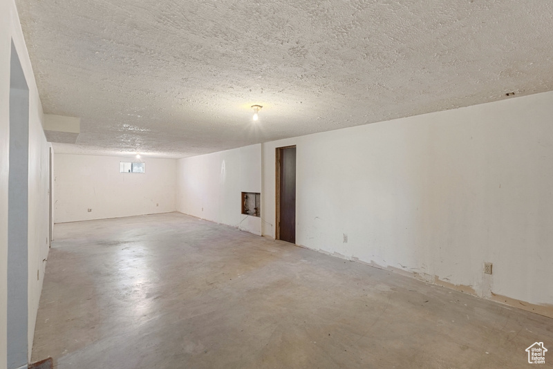 Below grade area with a textured ceiling