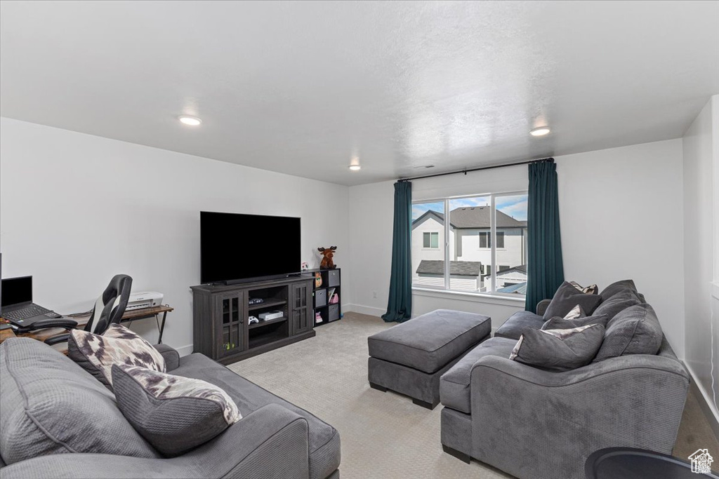 Carpeted living room featuring baseboards