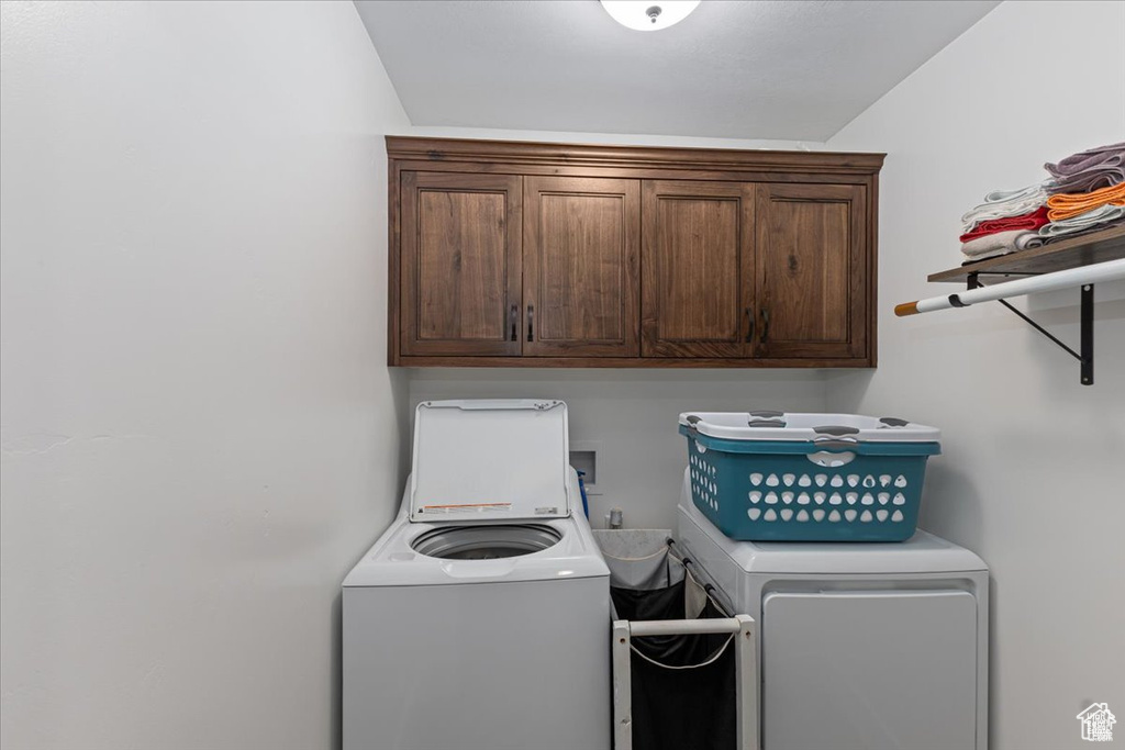 Laundry area featuring cabinet space and separate washer and dryer