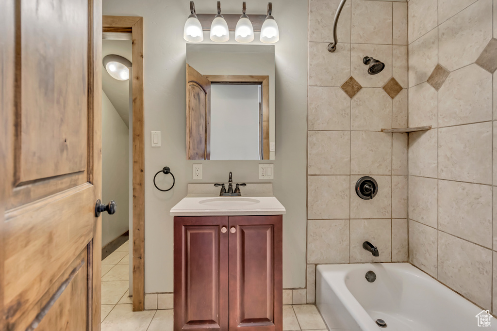 Full bath featuring tile patterned floors, vanity, and bathing tub / shower combination