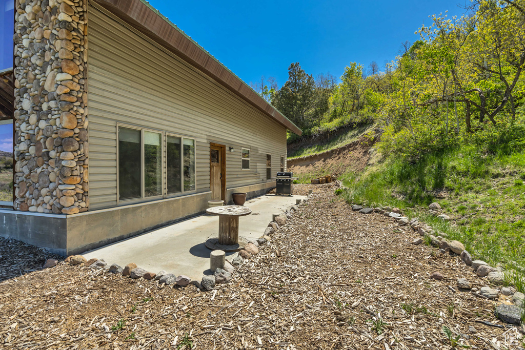 View of side of property with a patio