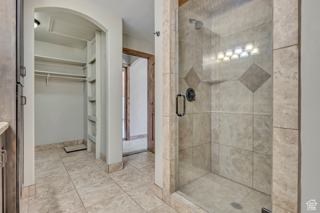 Full bath featuring a stall shower and a spacious closet