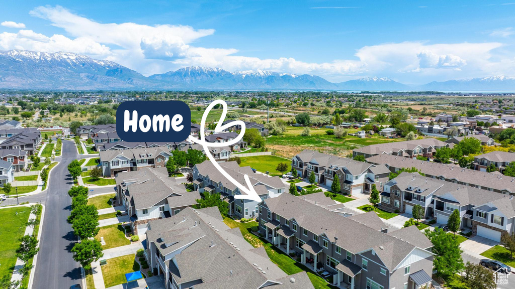Aerial perspective of suburban area featuring a mountainous background