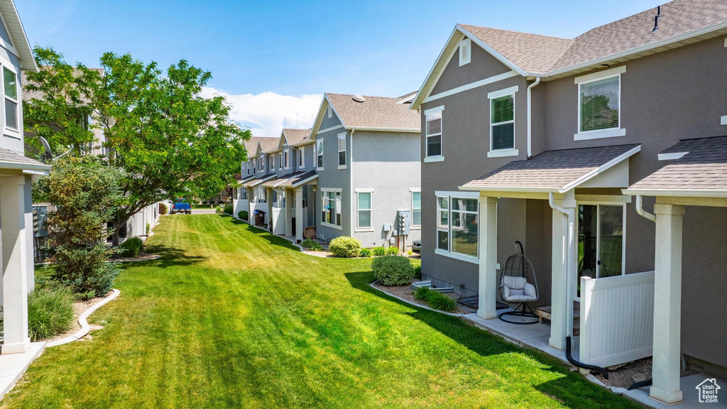 View of green lawn featuring a residential view