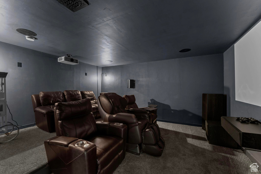 Carpeted cinema room with baseboards