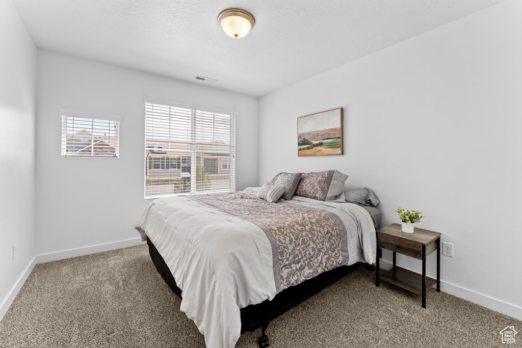 Bedroom with carpet flooring and baseboards