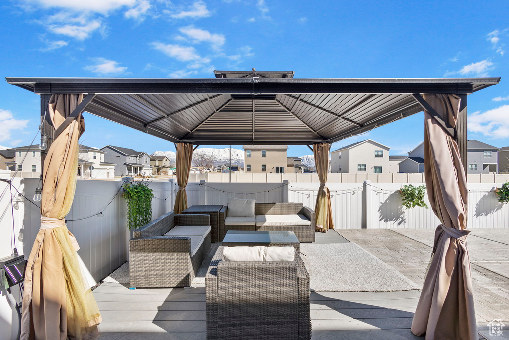 Wooden terrace with a gazebo, a residential view, a fenced backyard, and outdoor lounge area