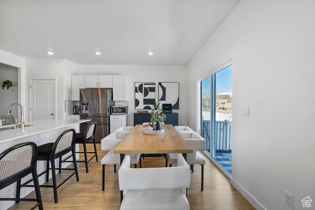 Dining room featuring light wood-style floors, recessed lighting, and baseboards