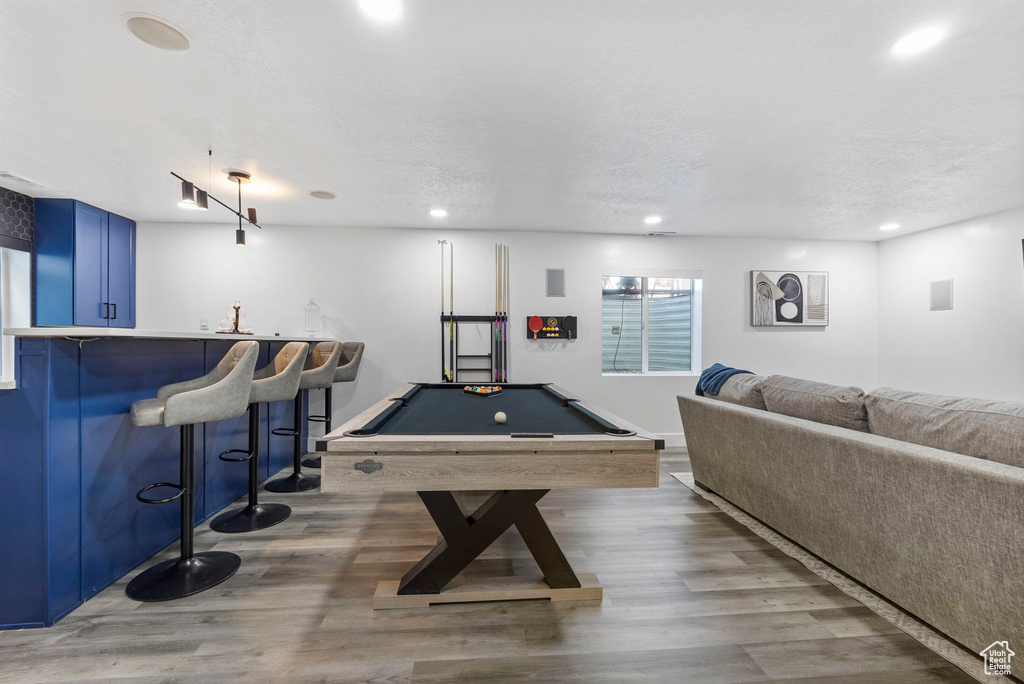 Game room with bar, billiards table, wood finished floors, and recessed lighting