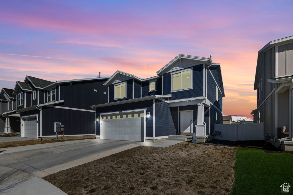 View of front of property with an attached garage and driveway